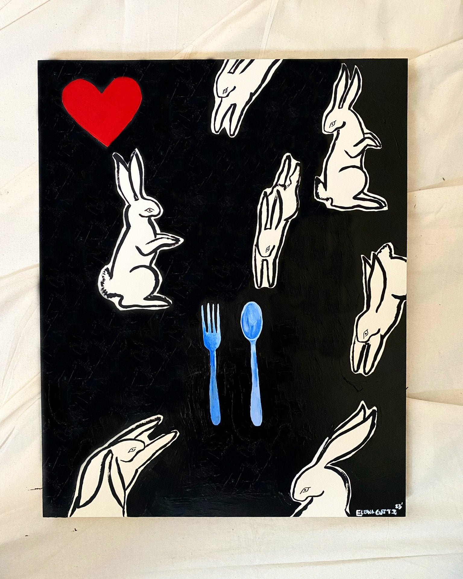 image of several bunnies in different positions. In the center of the canvas is a spoon and fork. In the top left corner is a heart
