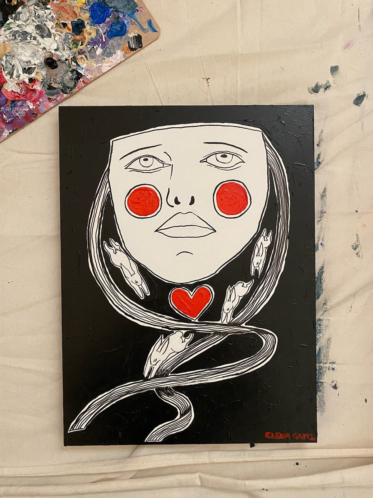 image of a mask with ribbons coming off the sides. Bunnies are depicted running on the ribbons